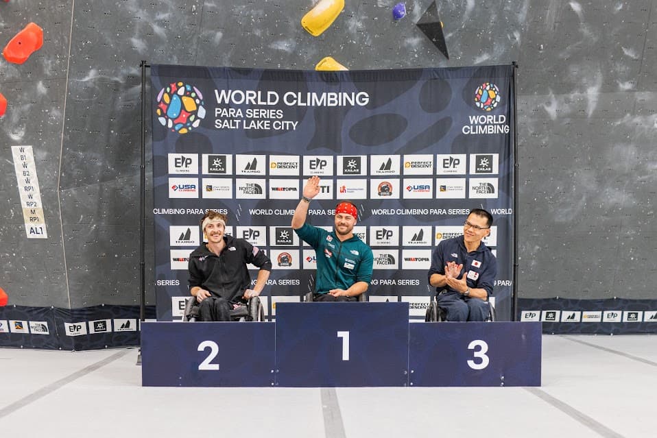 Caleb celebrating on top of the podium at the World Climbing Para Series in Salt Lake City
